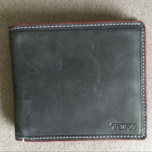 Tumi black leather wallet with red trim